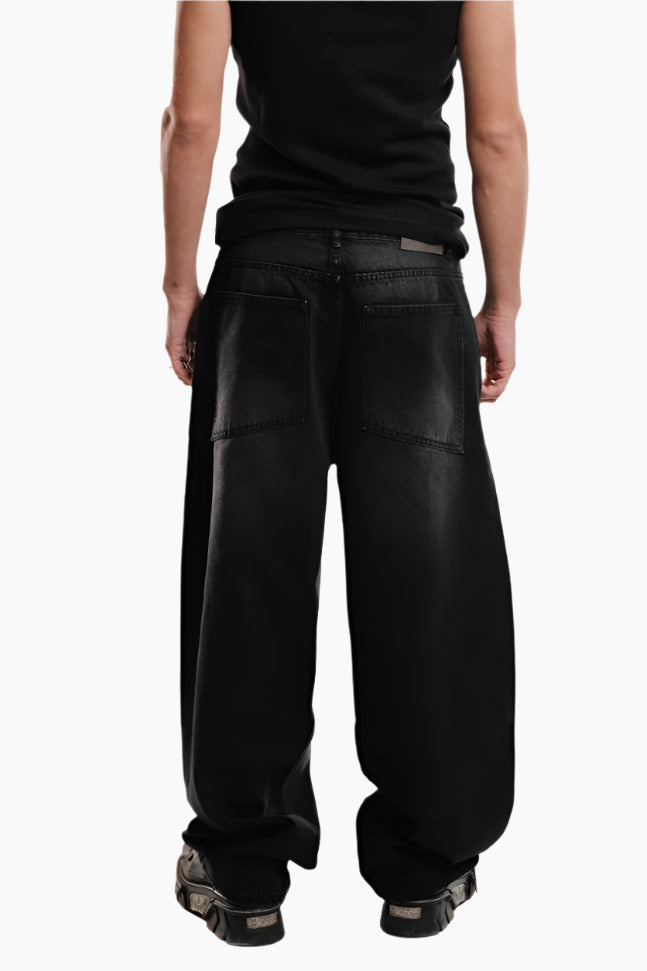 Person wearing black wide-leg pants and a black top