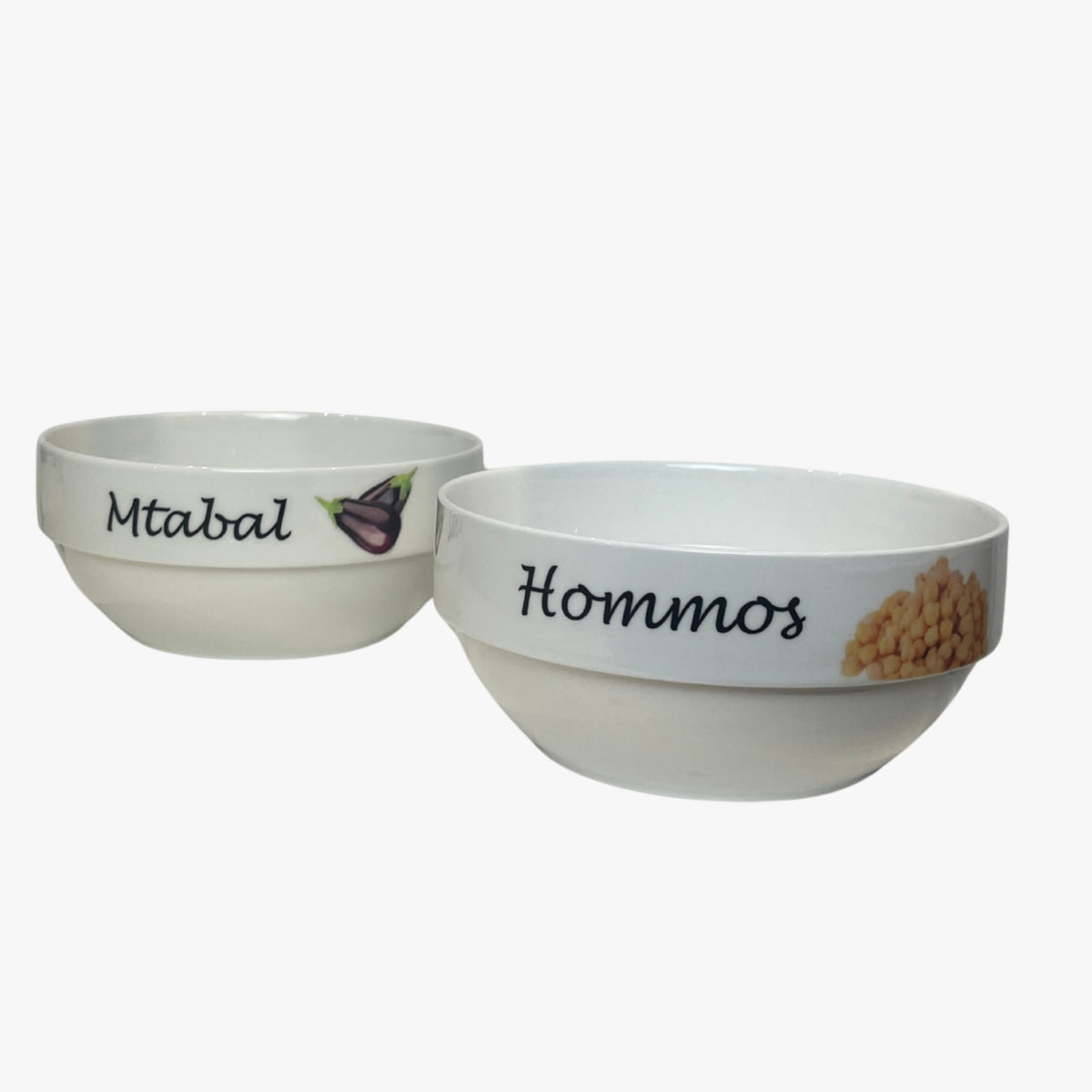Two medium-sized white porcelain bowls with black text and illustrations of food items on the labels 'Mtabal' and 'Hommus'.