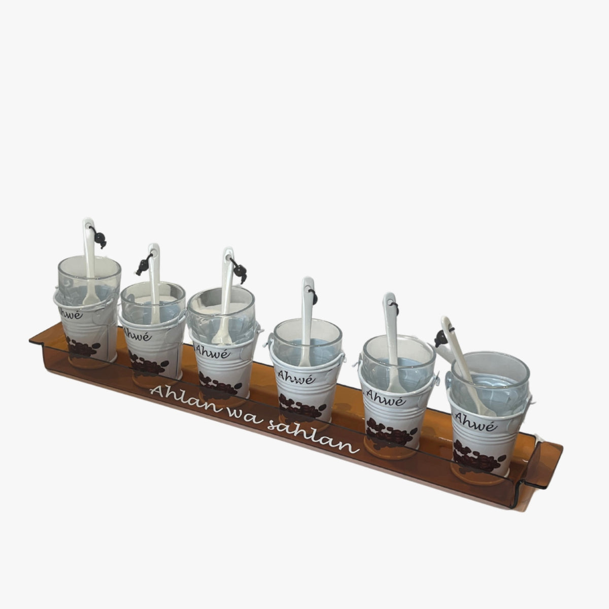 A set of six white espresso buckets with silver spoons, arranged on a wooden tray with the inscription 'Ahlan wa sahlan' on the front.