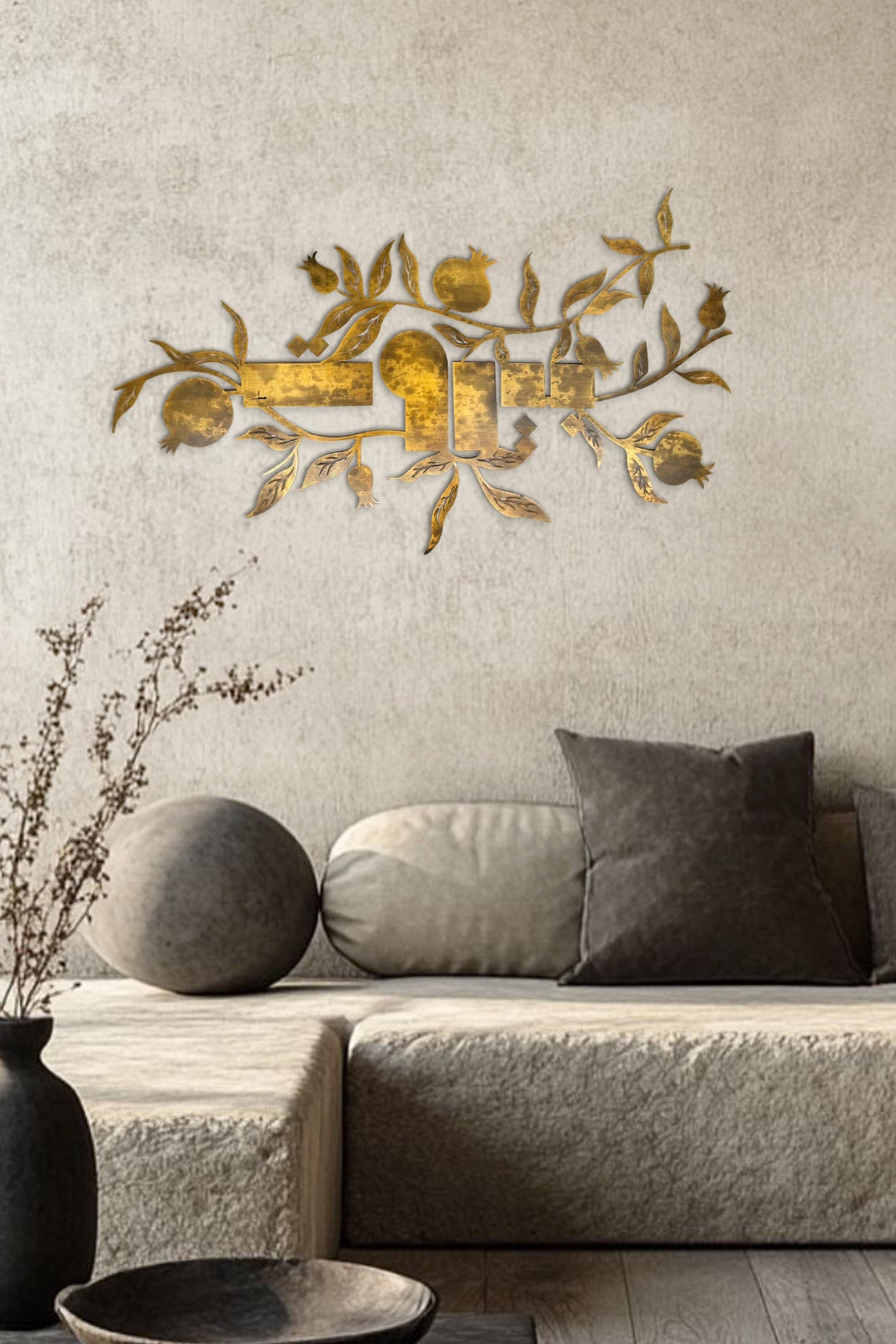 Decorative wall art with floral design above a sofa in a living room setting.