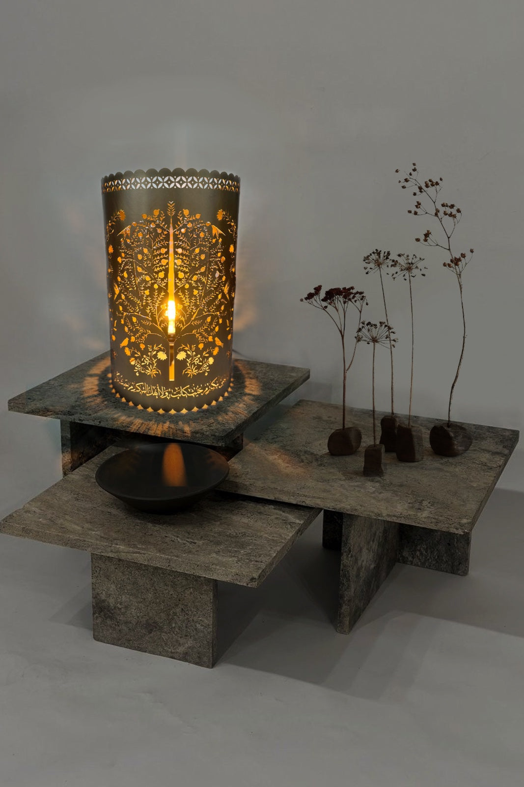 Decorative candle holder on a stone surface with a soft light