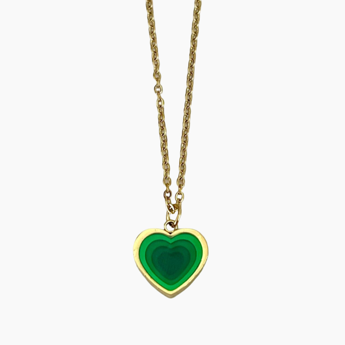 Gold necklace with a green heart-shaped pendant on a white background