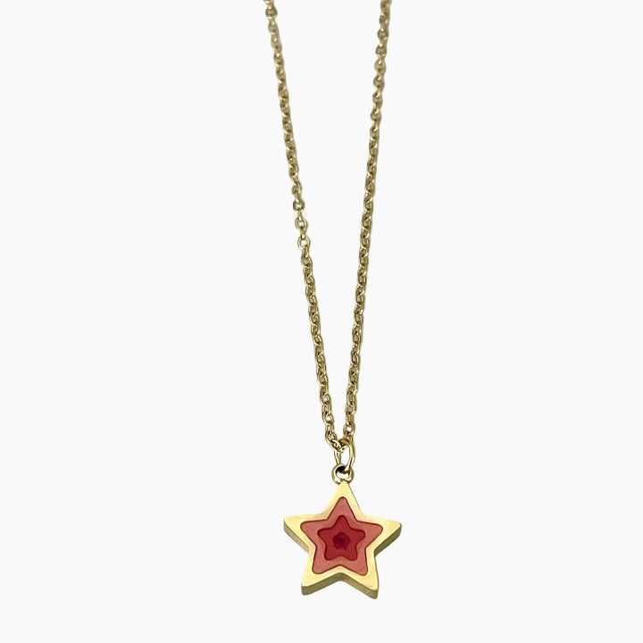 Gold necklace with a red star pendant on a white background