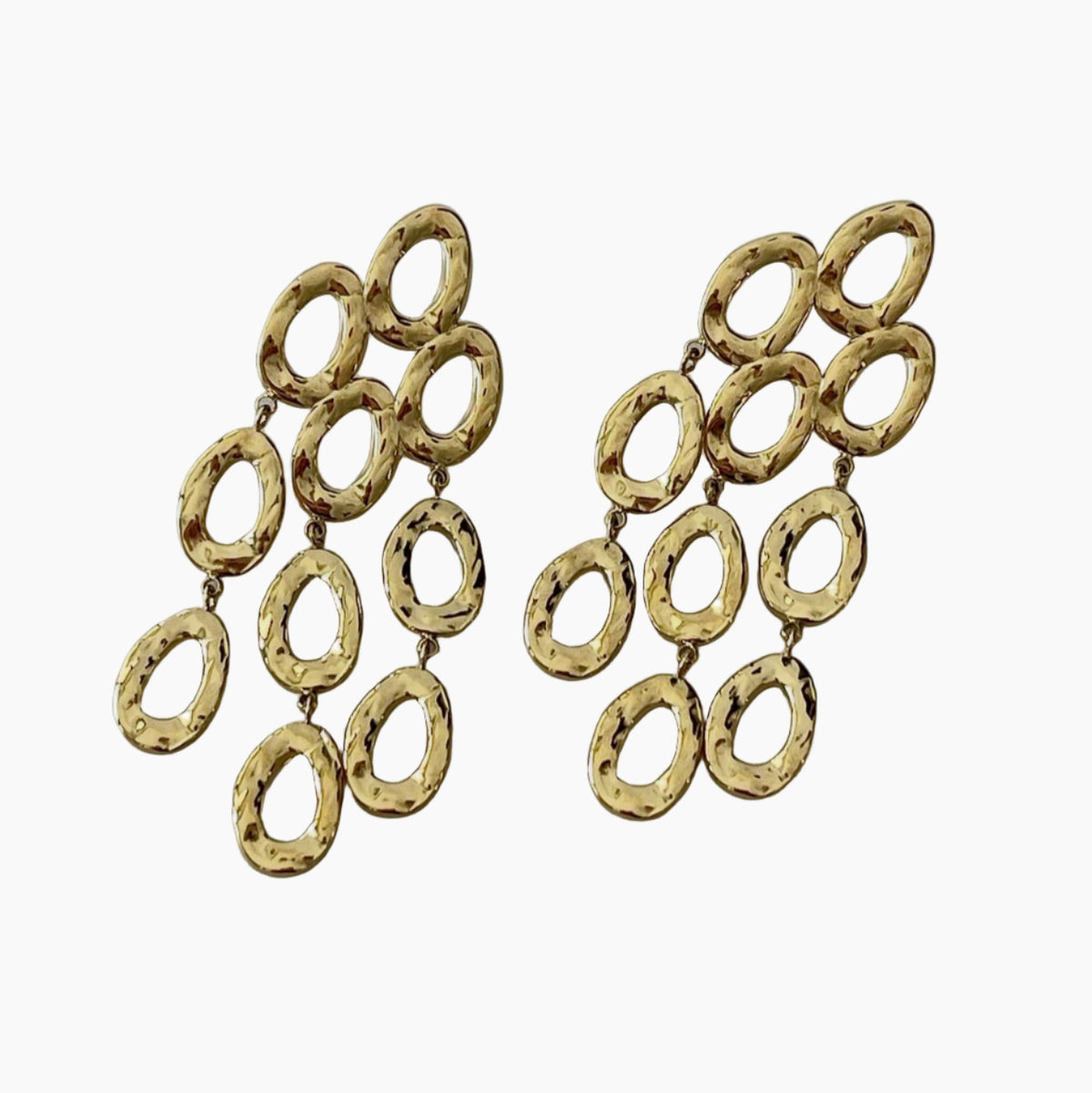 Gold chandelier earrings on a white background