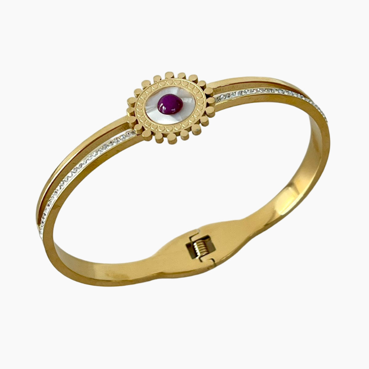 Gold bracelet with a central gemstone on a white background
