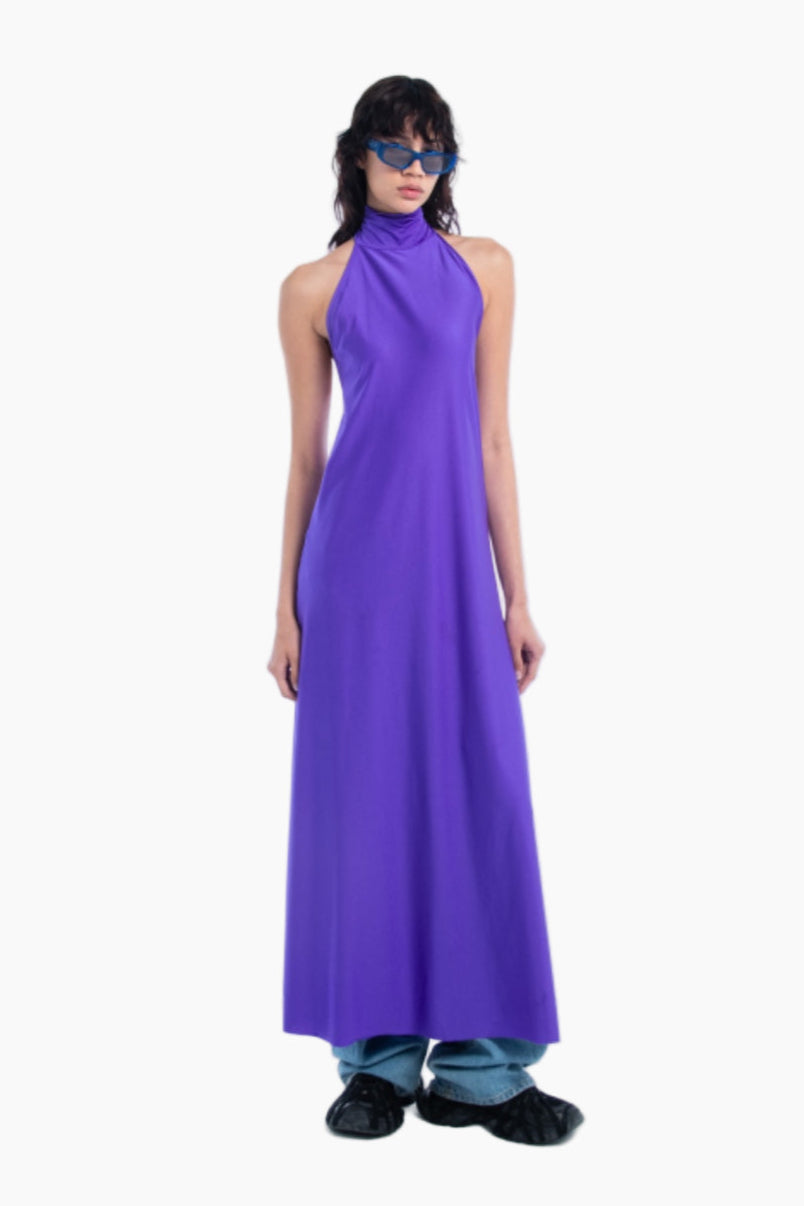Woman wearing a long purple dress on a white background