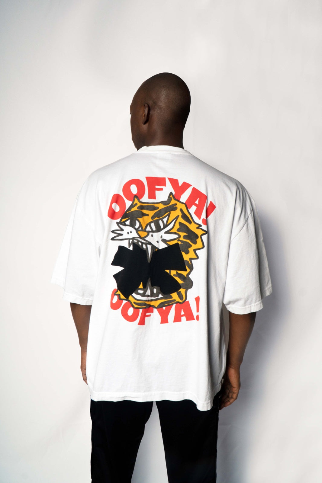 Person wearing a white t-shirt with a colorful graphic design on the back, White Printed T-shirt(Tiger)