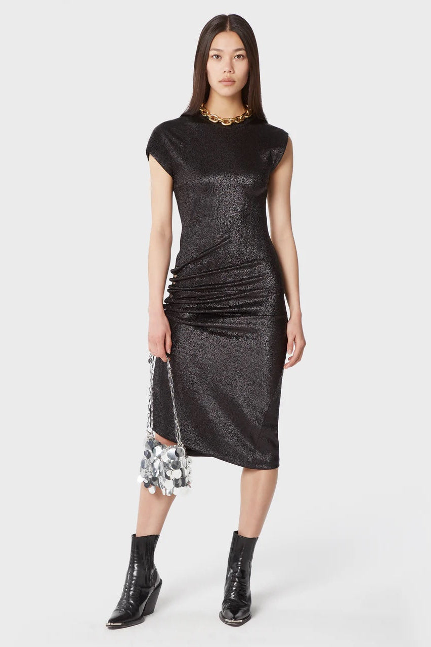 Woman wearing a black metallic dress with sheer floral details on a white background