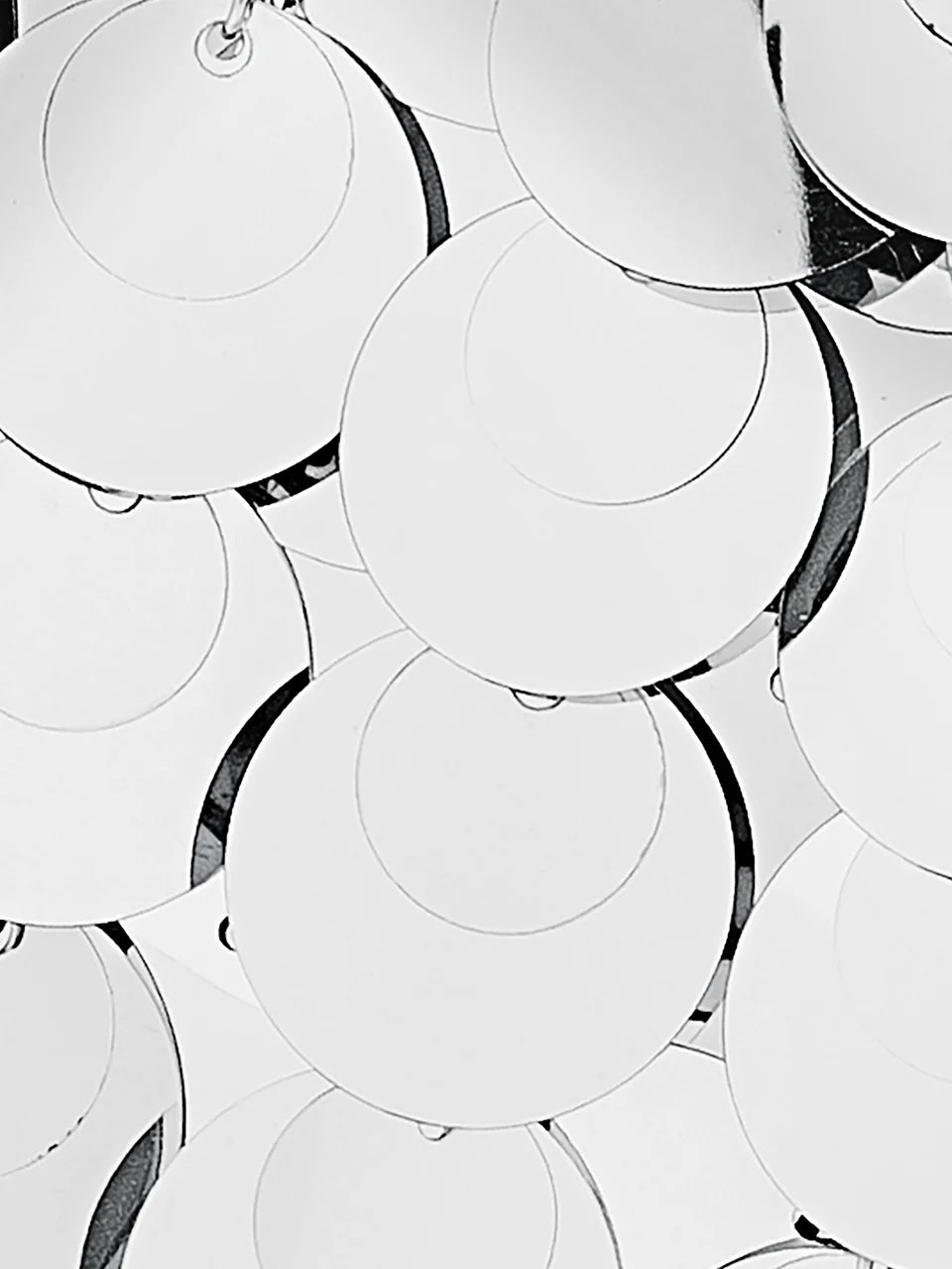Close-up of reflective circular objects on a white background