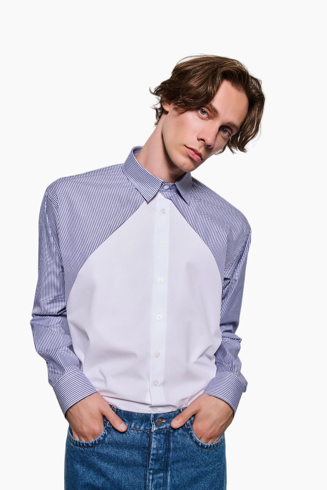 Person wearing a two-tone shirt with blue and white pattern on a white background