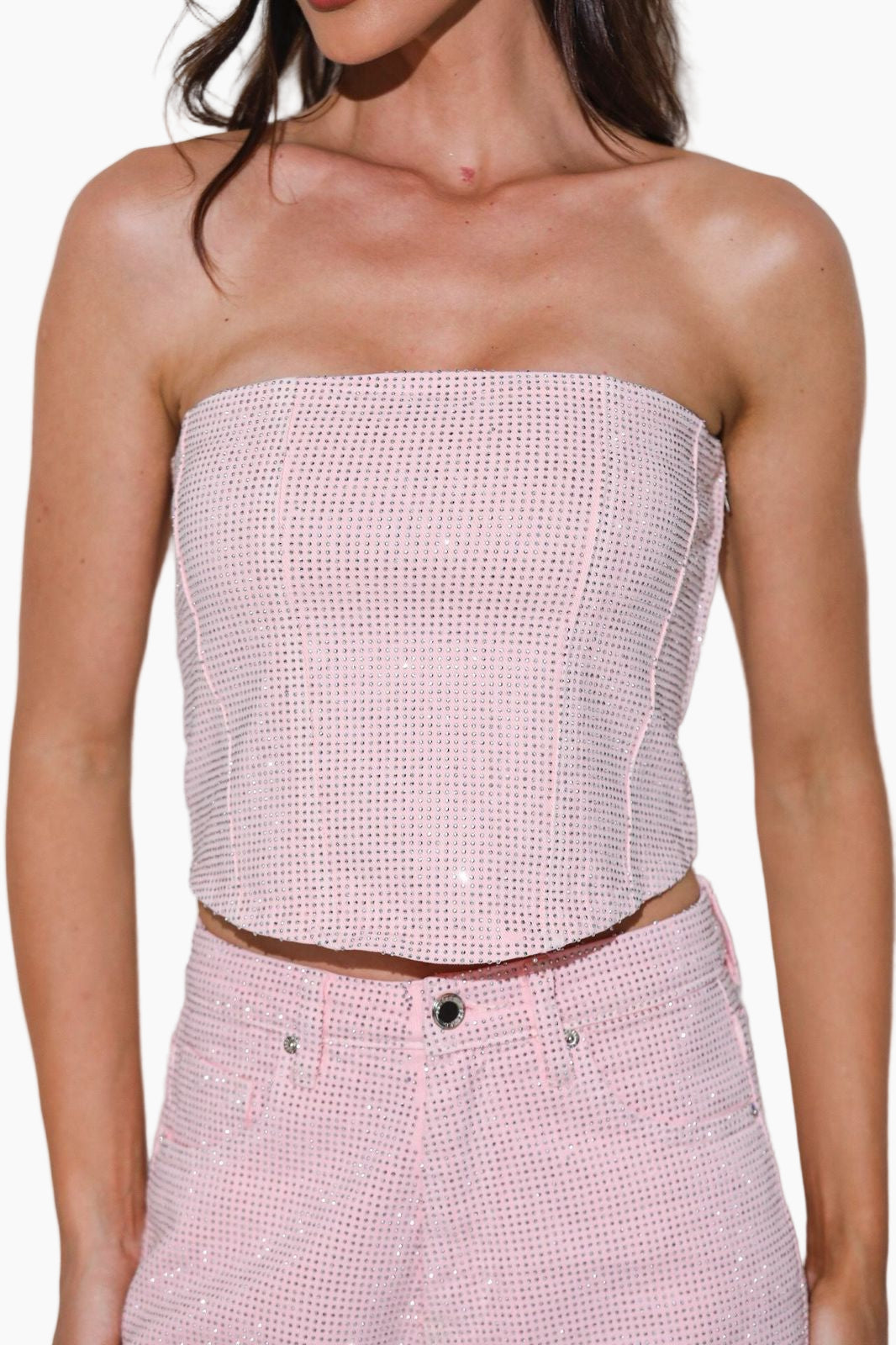 Woman wearing a strapless pink top and matching pants