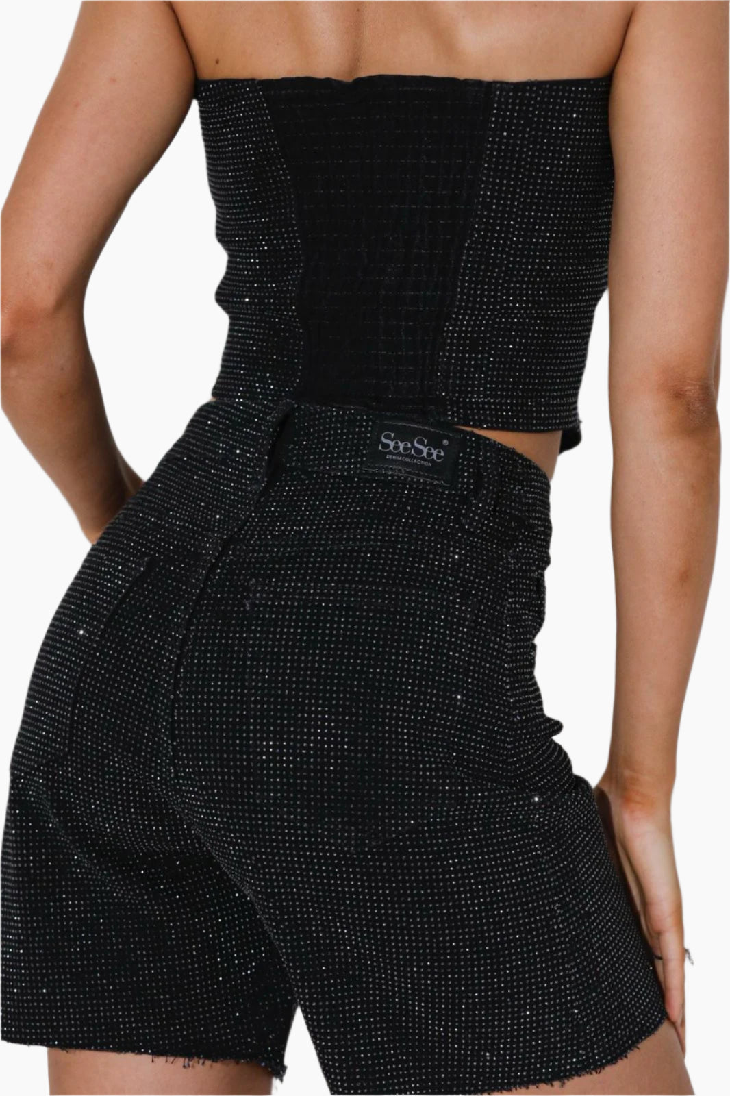 Black sparkly outfit with a brand logo