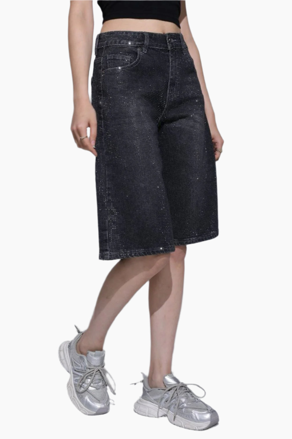 Person wearing dark denim shorts