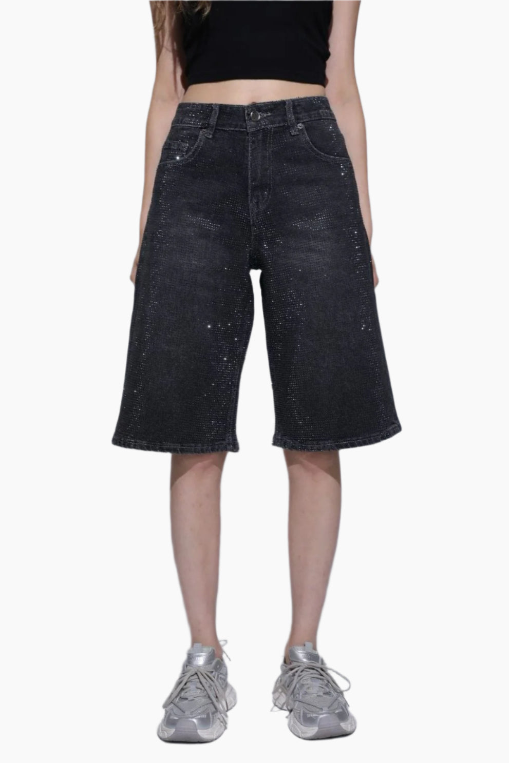 Person wearing black denim shorts