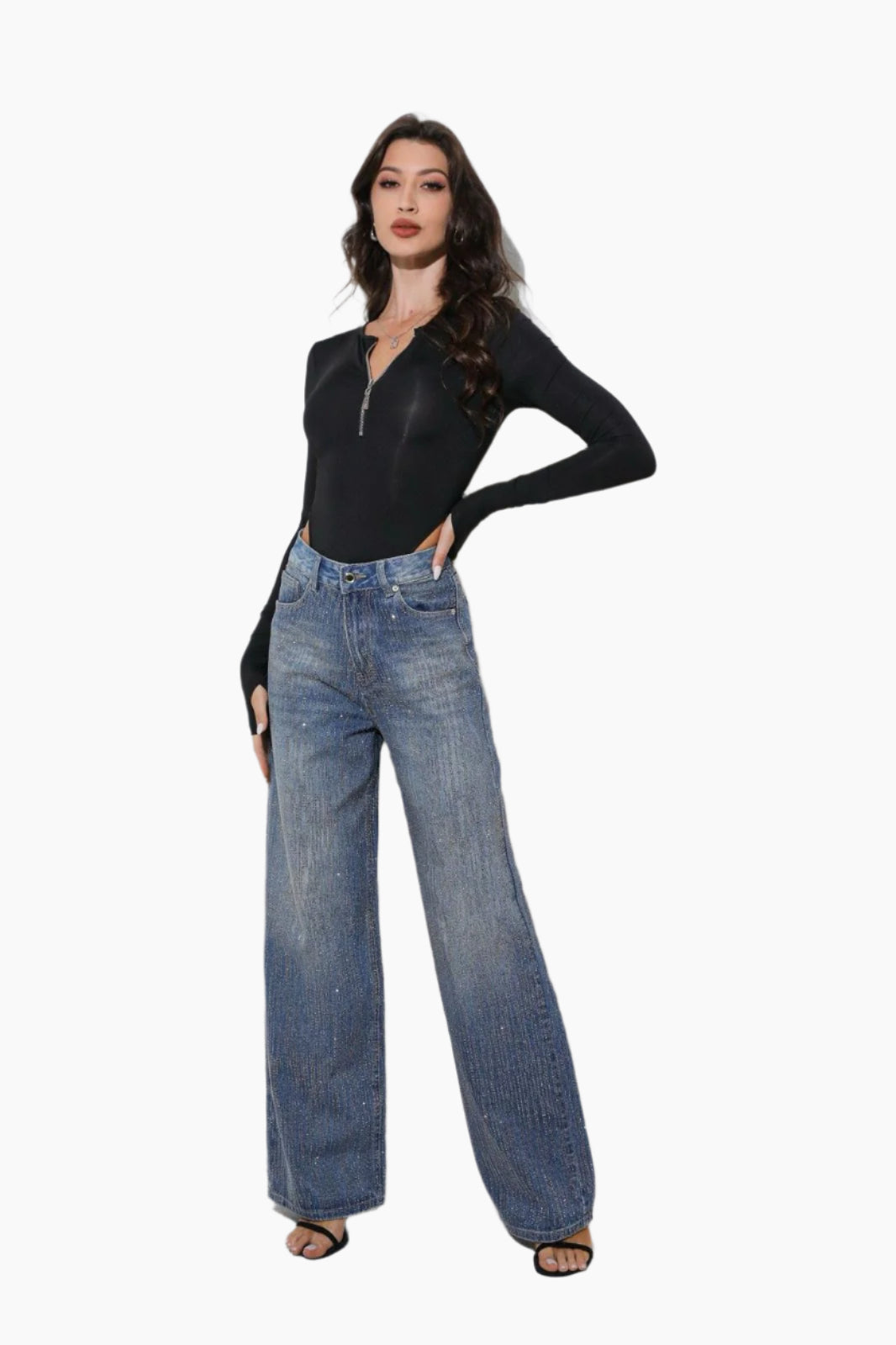 Woman wearing a black long-sleeve top and blue jeans
