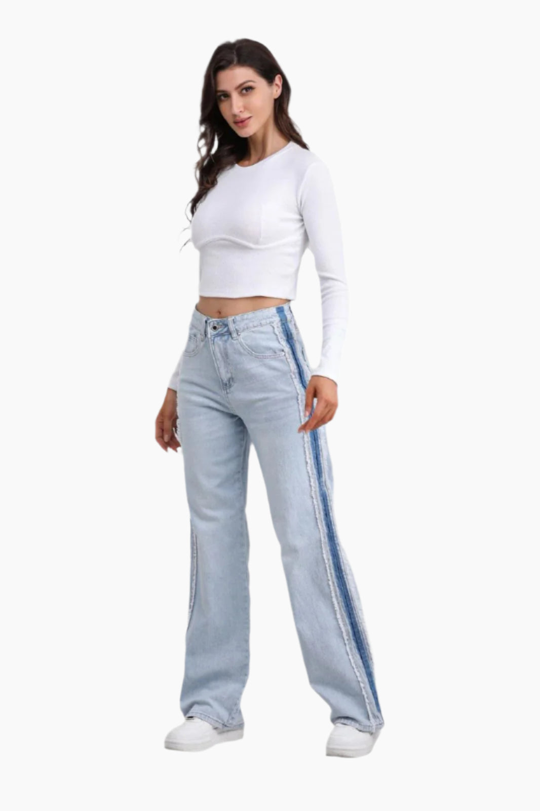 Woman wearing light blue jeans with a stripe and a white top