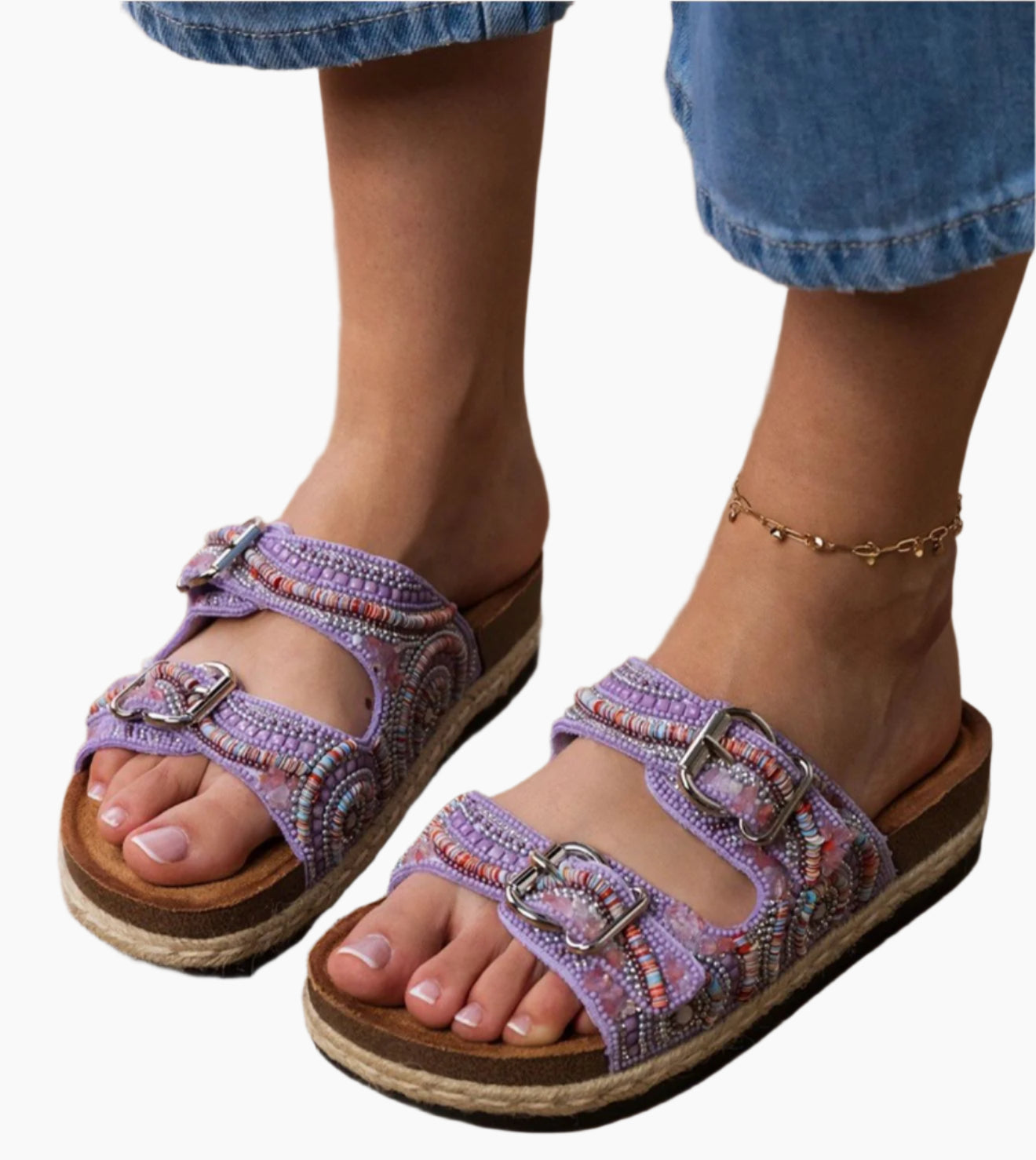 Purple sandals with decorative straps worn