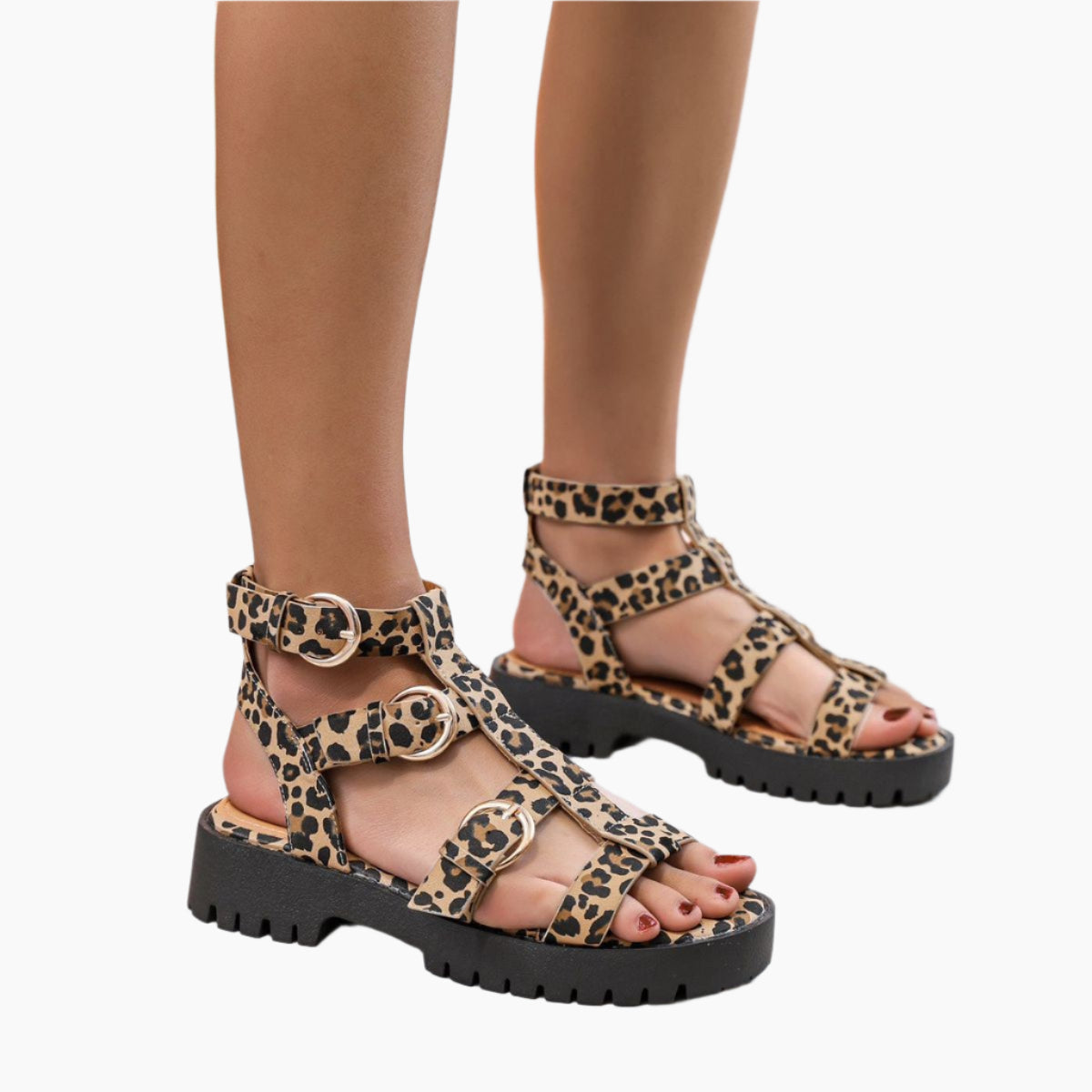 Leopard print sandals with black soles worn by a person