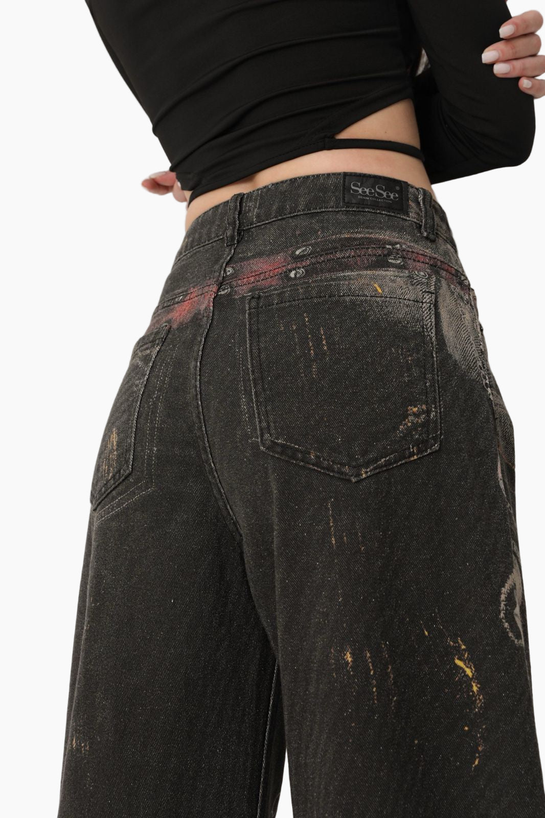 Black distressed jeans worn by a person