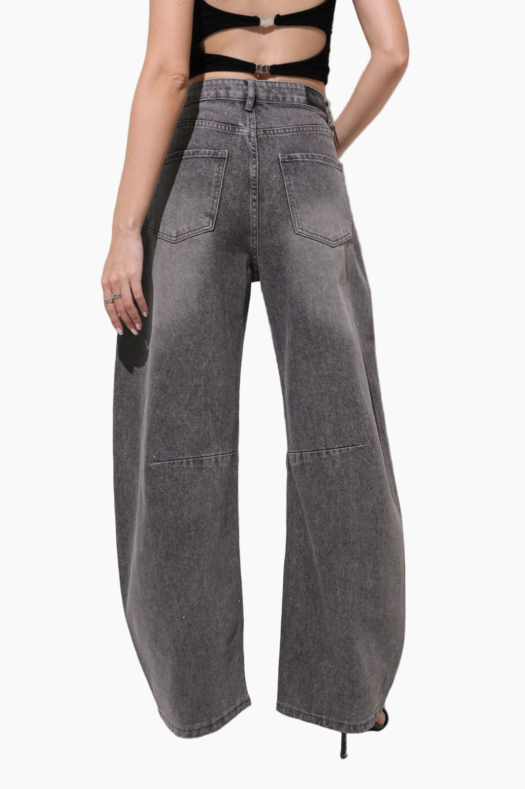 Person wearing high-waisted gray jeans