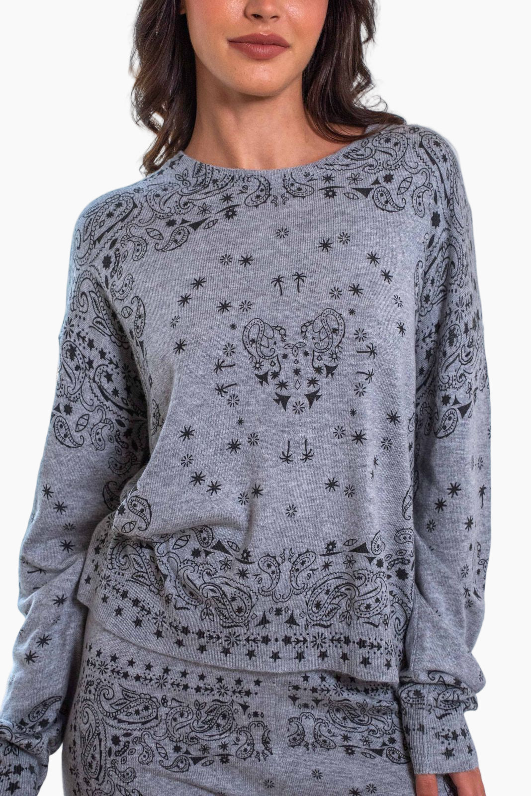 Gray sweatshirt with black patterns worn by a model