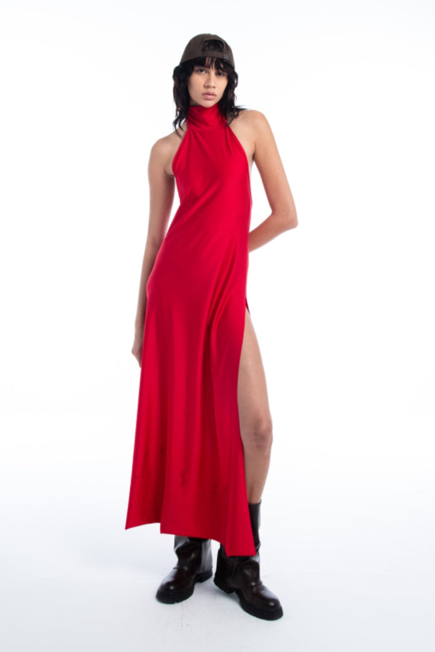 Woman wearing a red halter neck dress with a slit