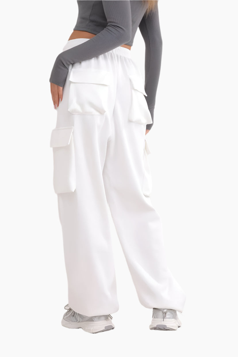 White cargo pants worn by a person on a white background