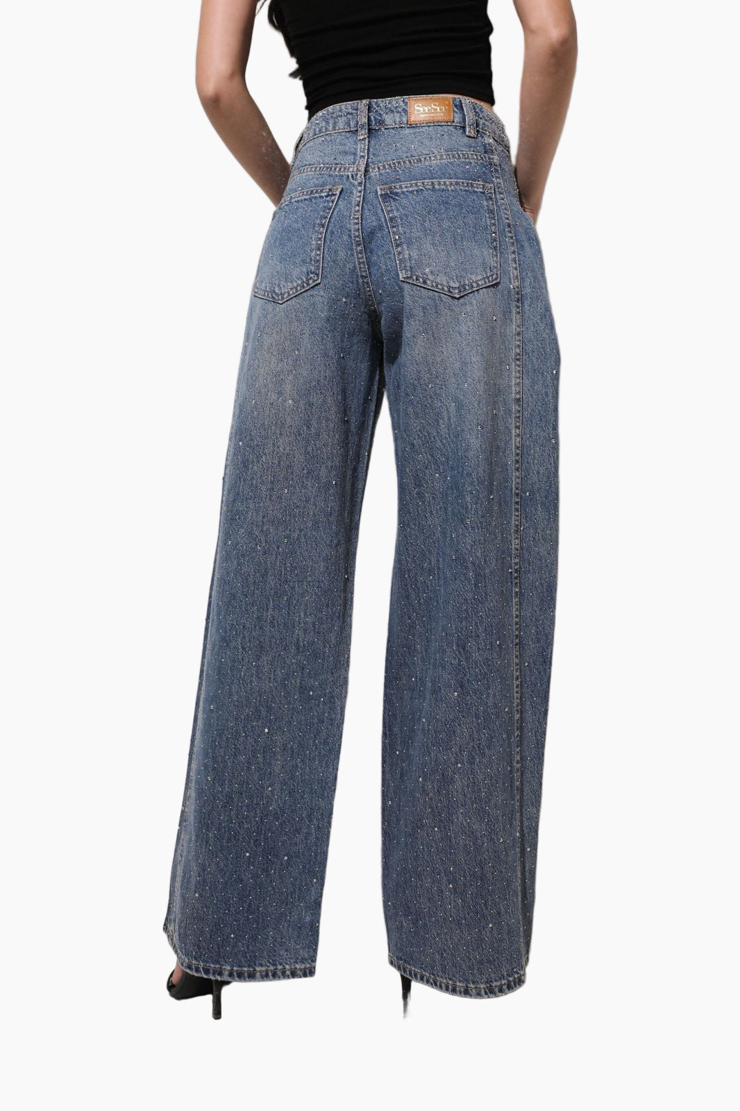 Person wearing blue jeans on a white background