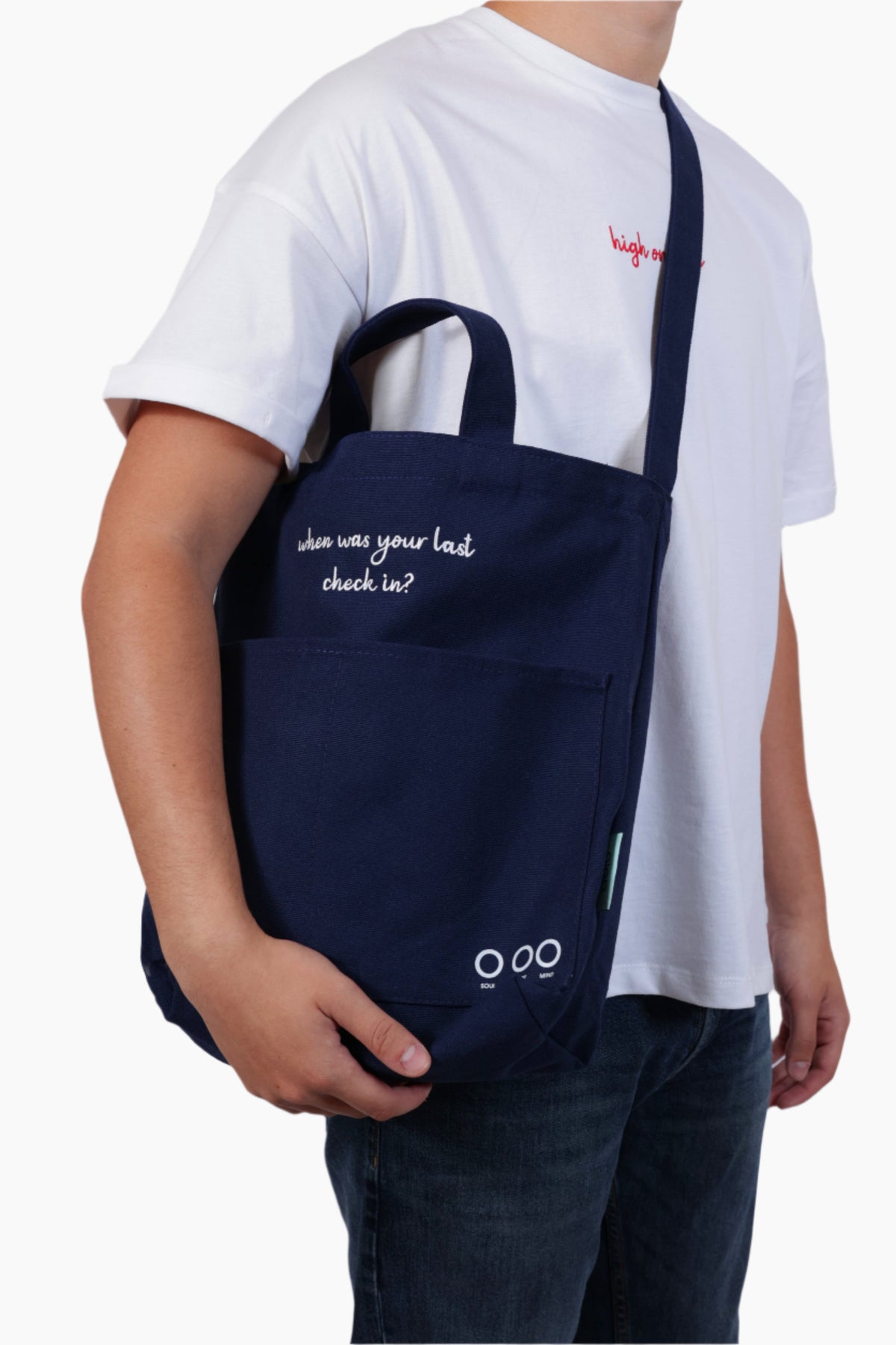 Person wearing a navy blue bag "When was your last check in?" - Unisex Tote Bag