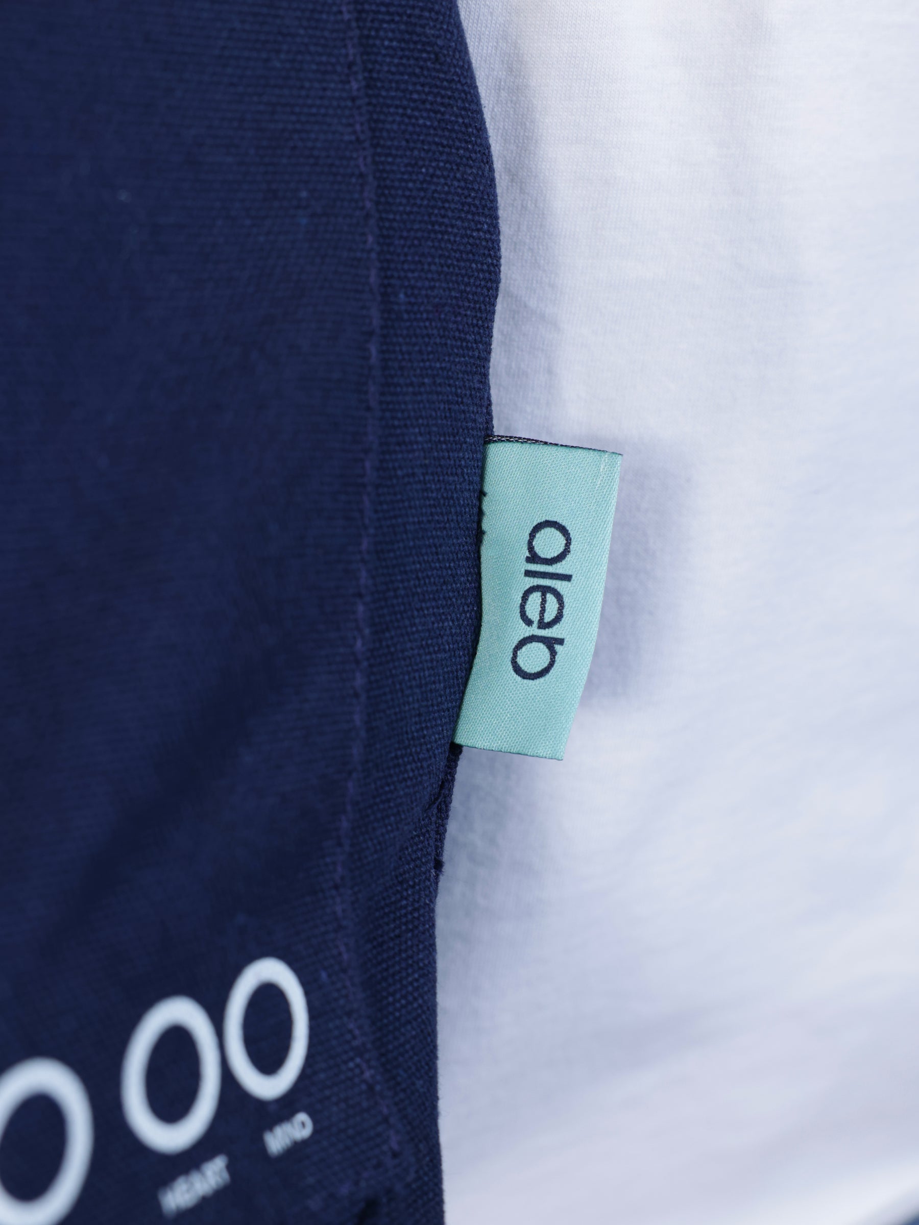 Person wearing a navy blue bag "When was your last check in?" - Unisex Tote Bag
