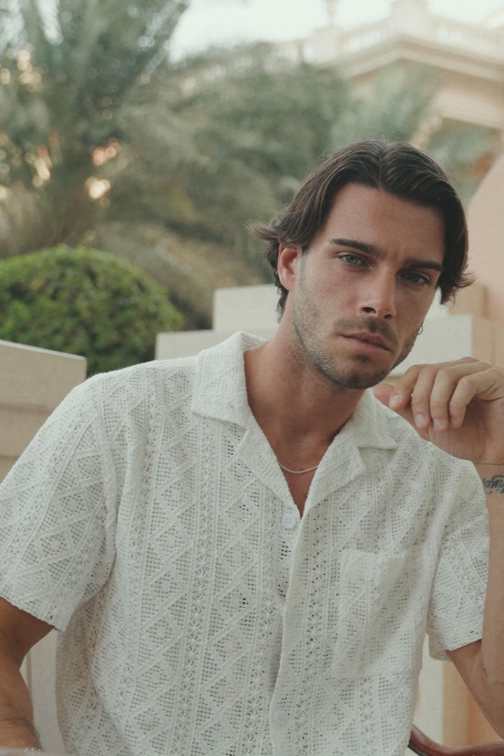 Man wearing a light-colored shirt outdoors