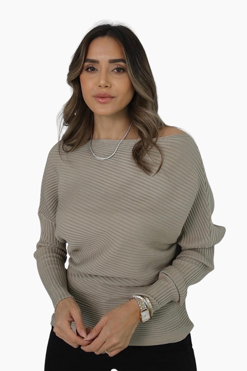 Woman wearing a beige ribbed sweater