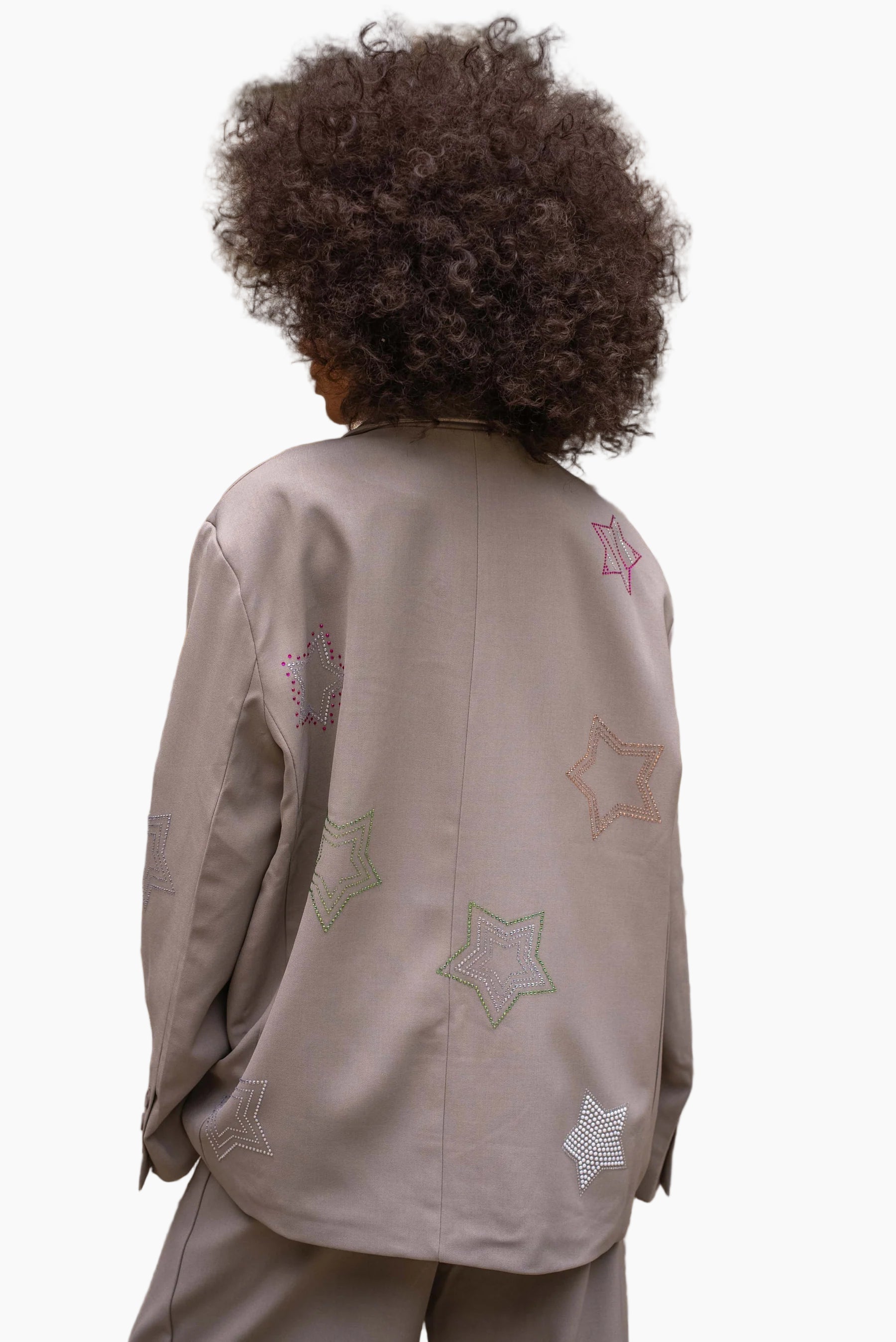 Person wearing a beige jacket with star patterns