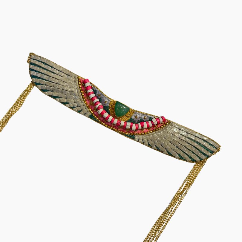 Decorative headpiece with wings and gold accents