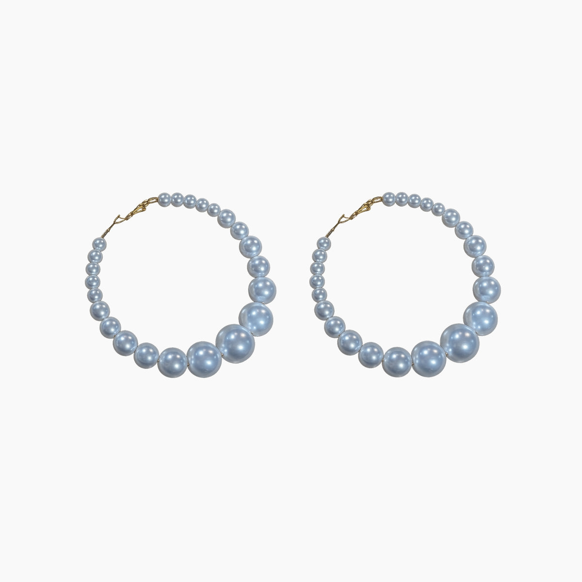 Pair of pearl hoop earrings on a white background