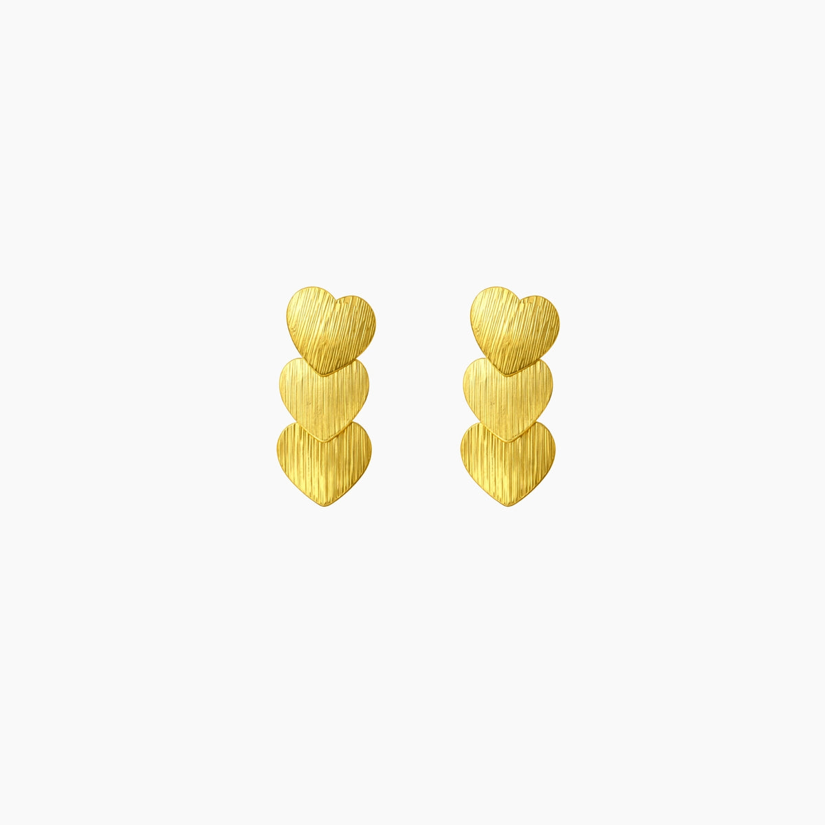 Pair of gold heart-shaped earrings on a white background