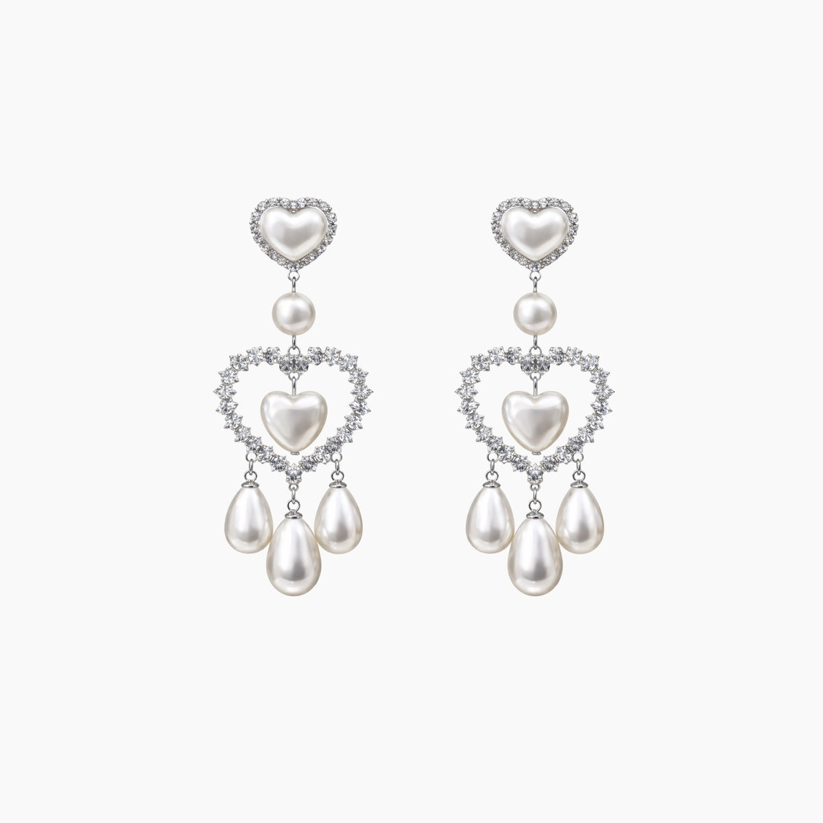 Pair of heart-shaped pearl earrings on a white background