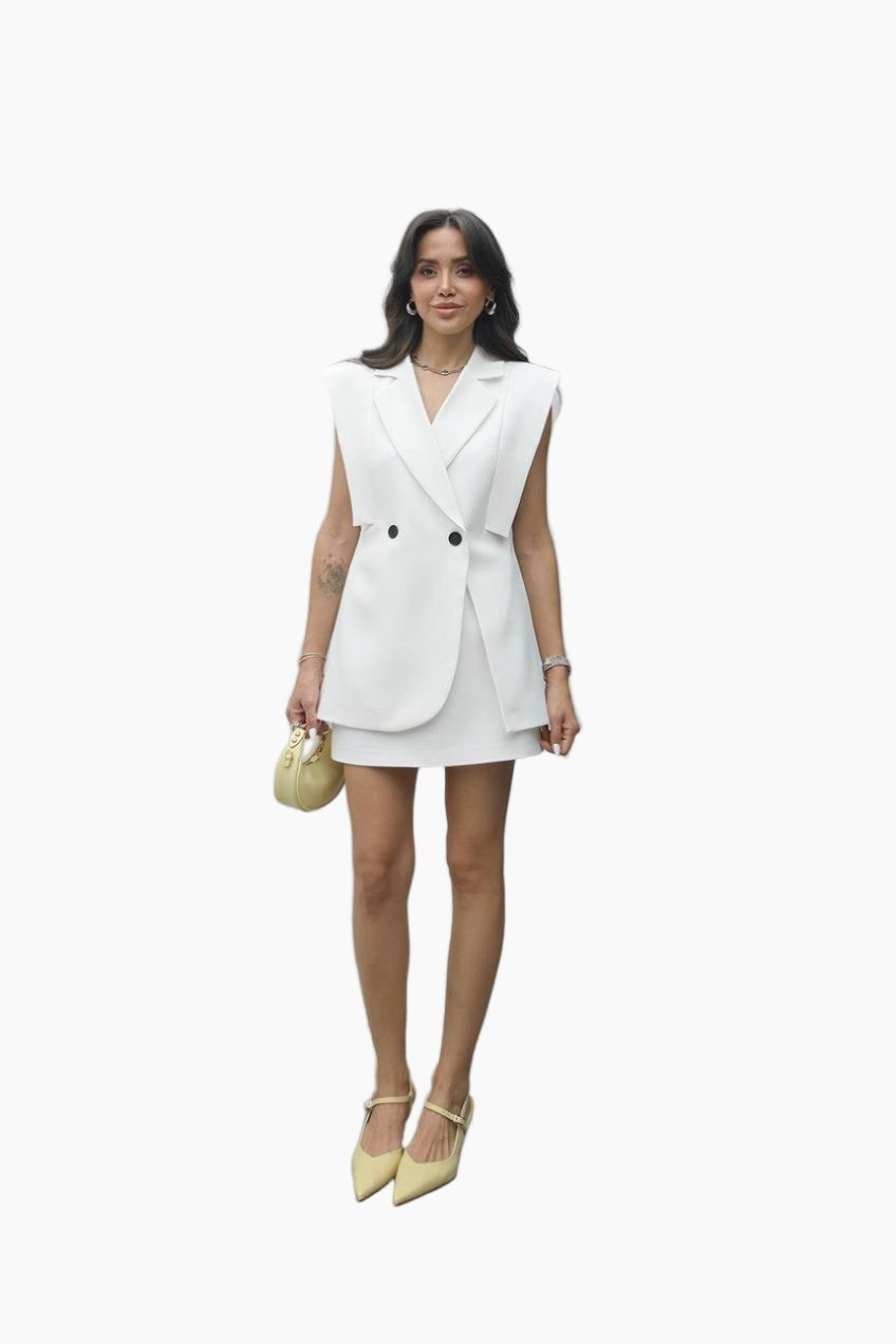 Woman wearing a white sleeveless blazer dress on a white background