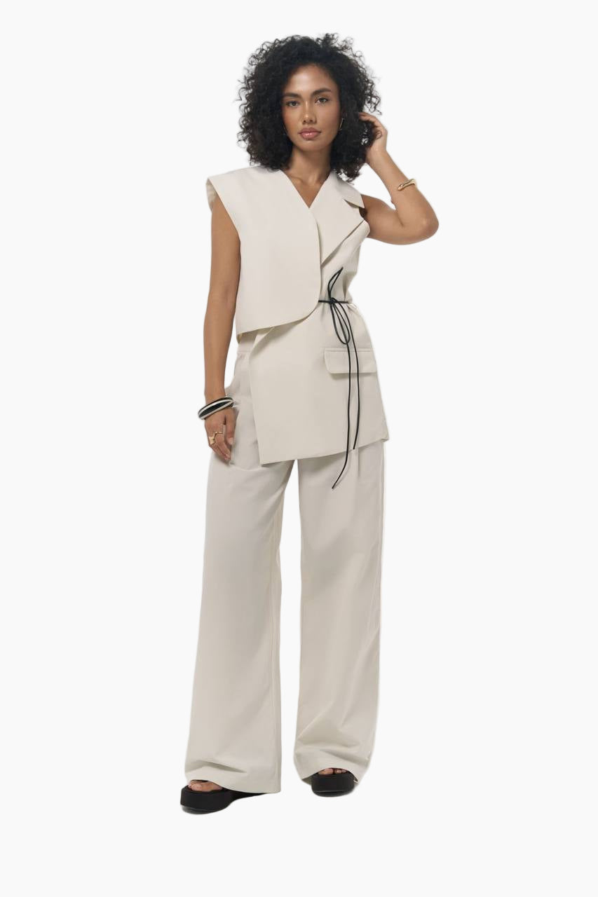 Woman wearing a beige outfit with a white background