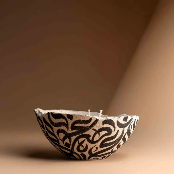 Ceramic bowl with black abstract patterns on a brown background