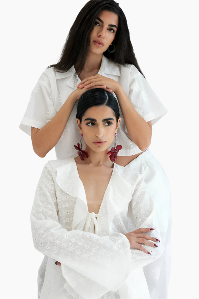 Two women wearing white shirts
