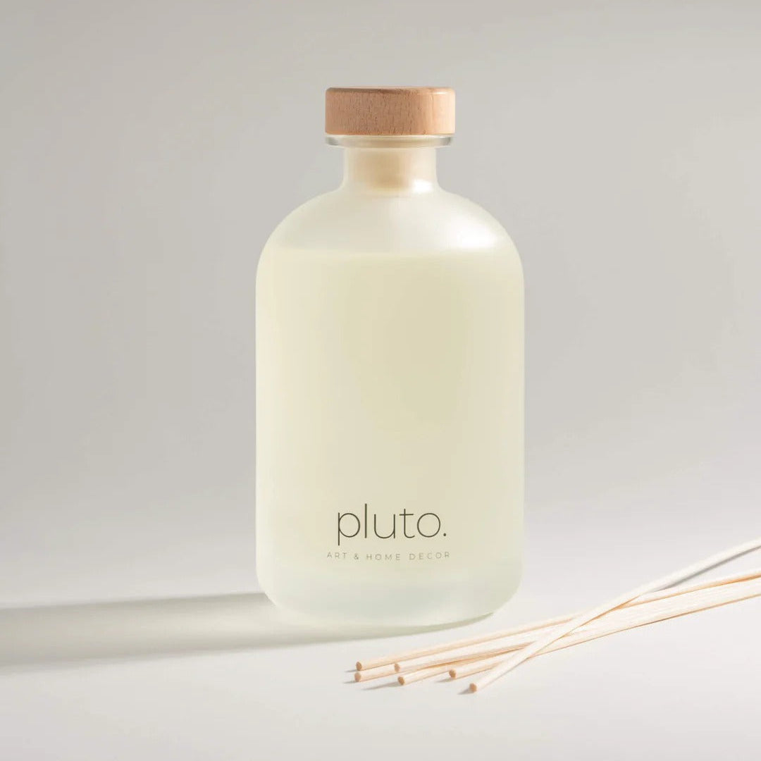 White bottle with wooden cap and 'pluto' branding on a light gray background