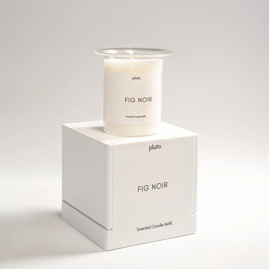 Candle labeled 'Fig Noir' by Pluto on a white box with the same label.