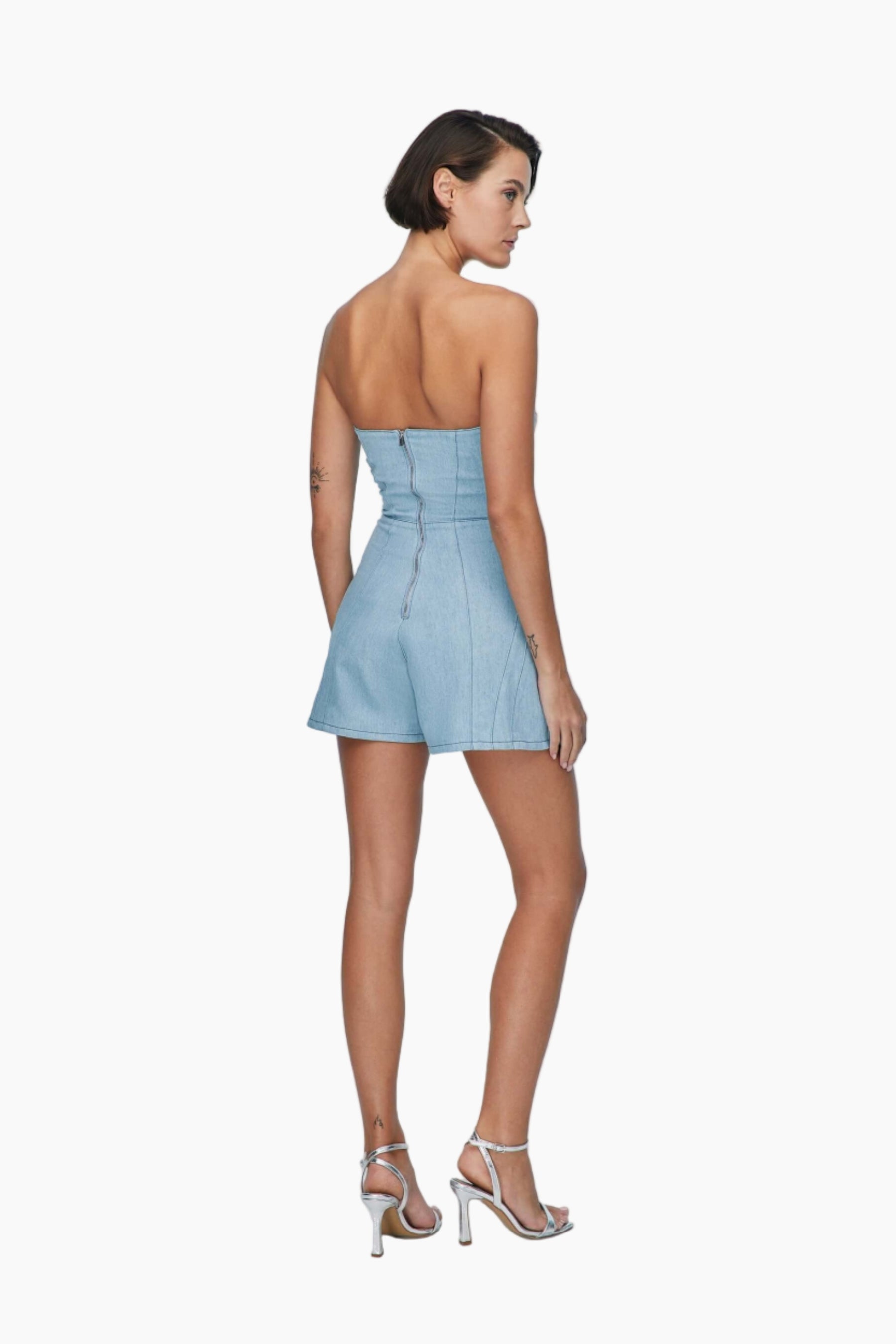 Woman wearing a light blue strapless romper