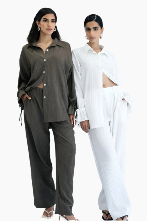 Two women wearing contrasting outfits.