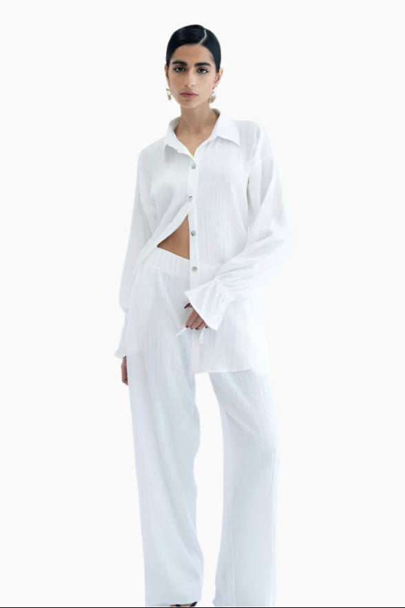 Person wearing a white outfit long sleeve shirt and pants
