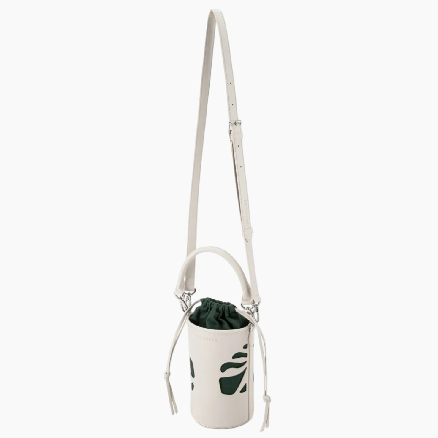 White crossbody bag with a plant inside on a white background