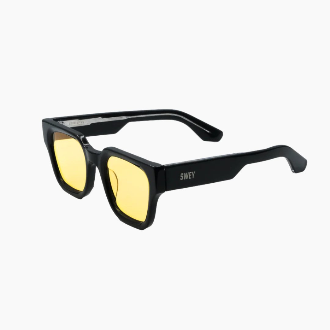 Black framed sunglasses with yellow lenses on a white background