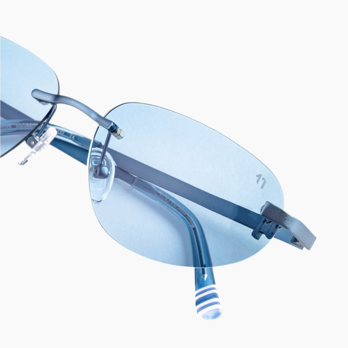 Blue rimless sunglasses with white stripped arms