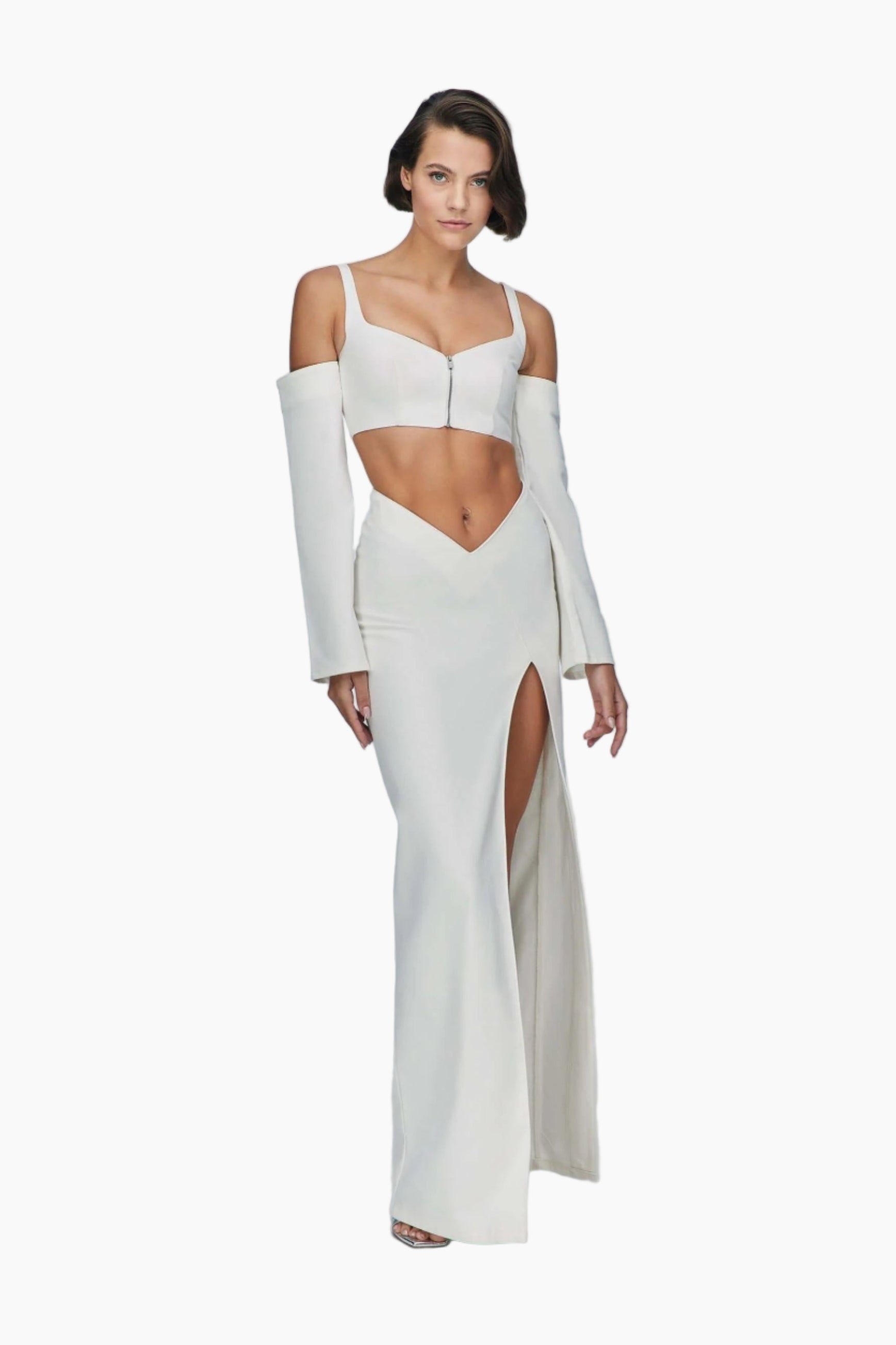 Woman wearing a white denim top with long sleeves and a high slit skirt